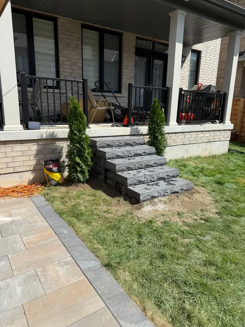 Stone steps with evergreen plantings at front entrance