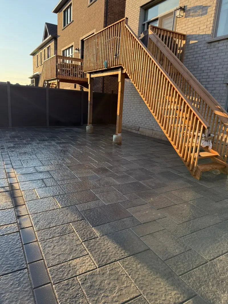 Interlocking patio with deck stairs at sunset